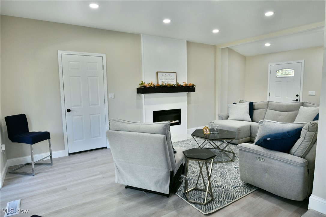 9633 Howland Springs Road Southeast Warren, OH 44484 - Photo 11 of 50 Living area with recessed lighting, light wood-style floors, and a fireplace