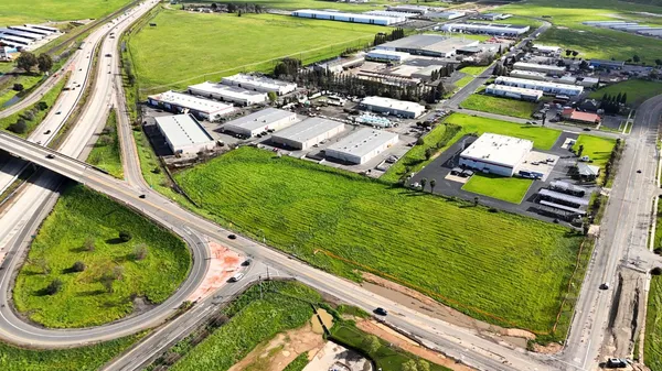 an aerial view of a residential houses with outdoor space and swimming pool