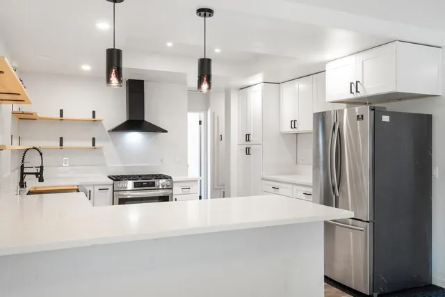 a kitchen with stainless steel appliances a refrigerator and a stove