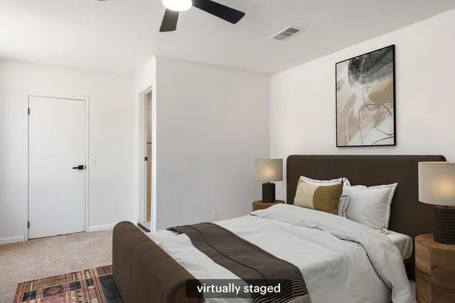 a bedroom with a bed and a painting on the wall