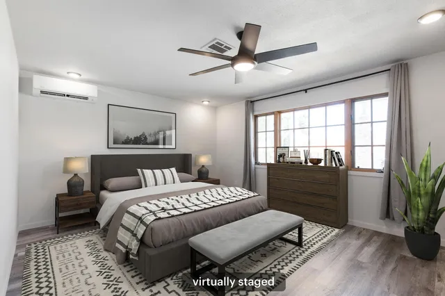 a bedroom with a large bed and a window