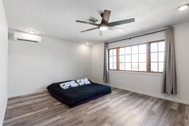 a view of a room with a ceiling fan a hardwood floor and a ceiling fan