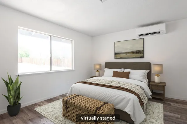 a bedroom with a bed and a potted plant
