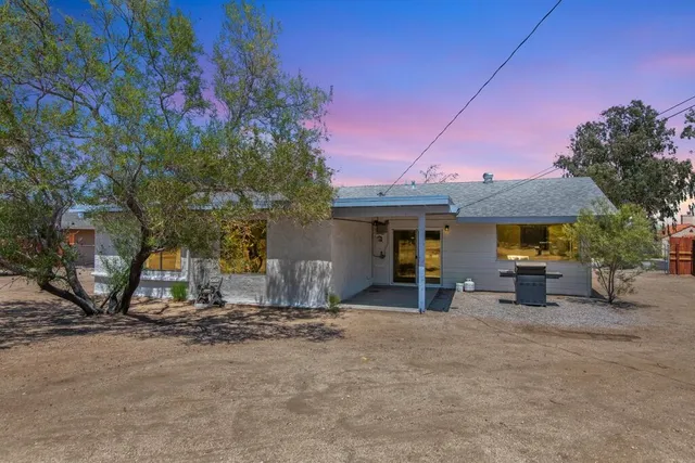 a group of people sitting in front of a house