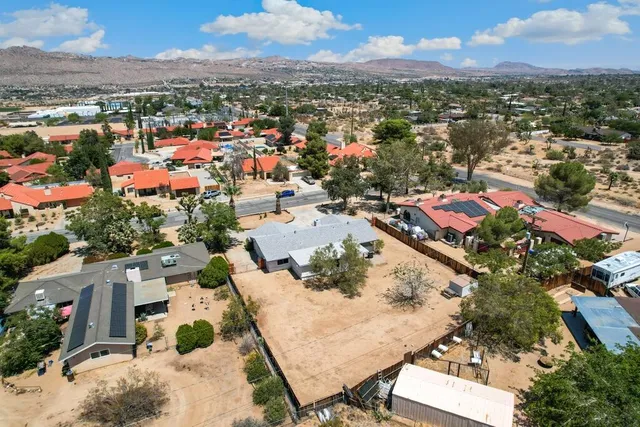 an aerial view of residential houses with outdoor space and river