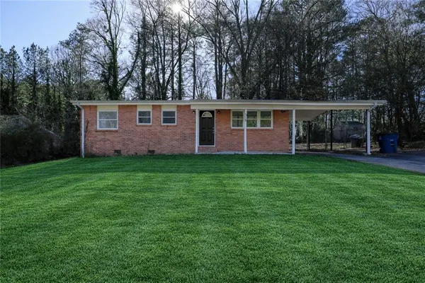 a front view of house with yard and green space