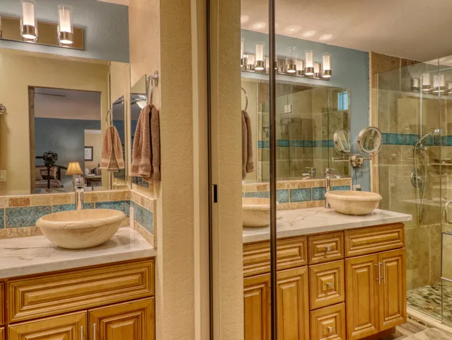 a bathroom with a shower sink and mirror