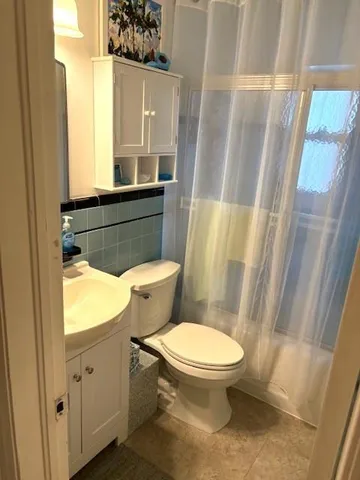 a white toilet sitting next to a sink