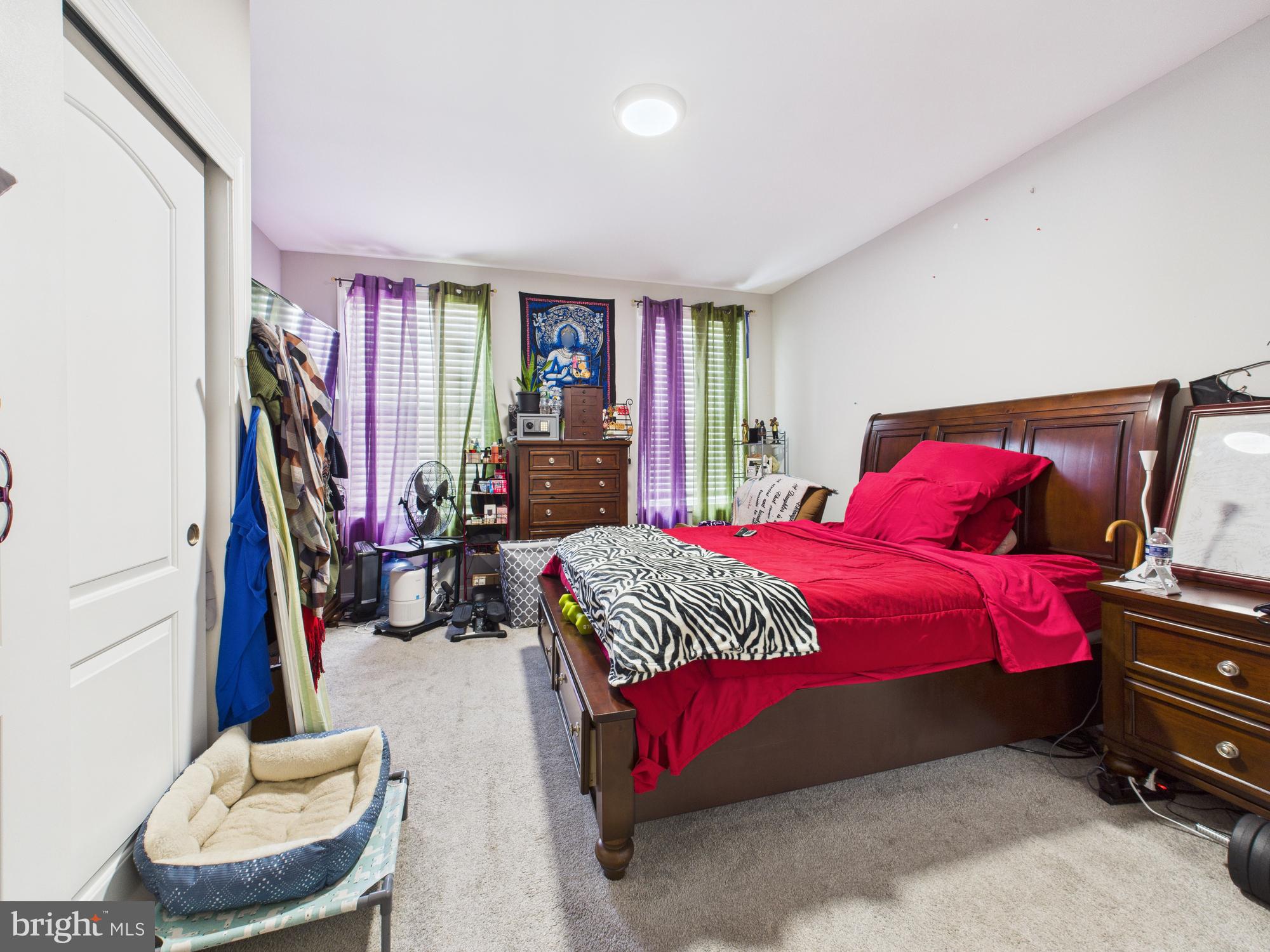 1526 North Patterson Park Avenue Baltimore, MD 21213 - Photo 18 of 31 a bedroom with a bed and wooden floor