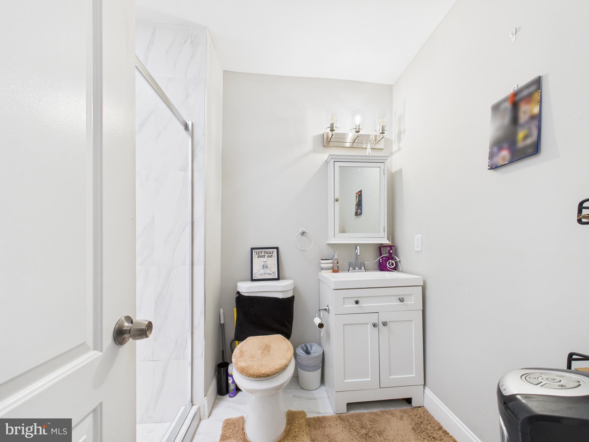 1526 North Patterson Park Avenue Baltimore, MD 21213 - Photo 20 of 31 a bathroom with a sink toilet and vanity