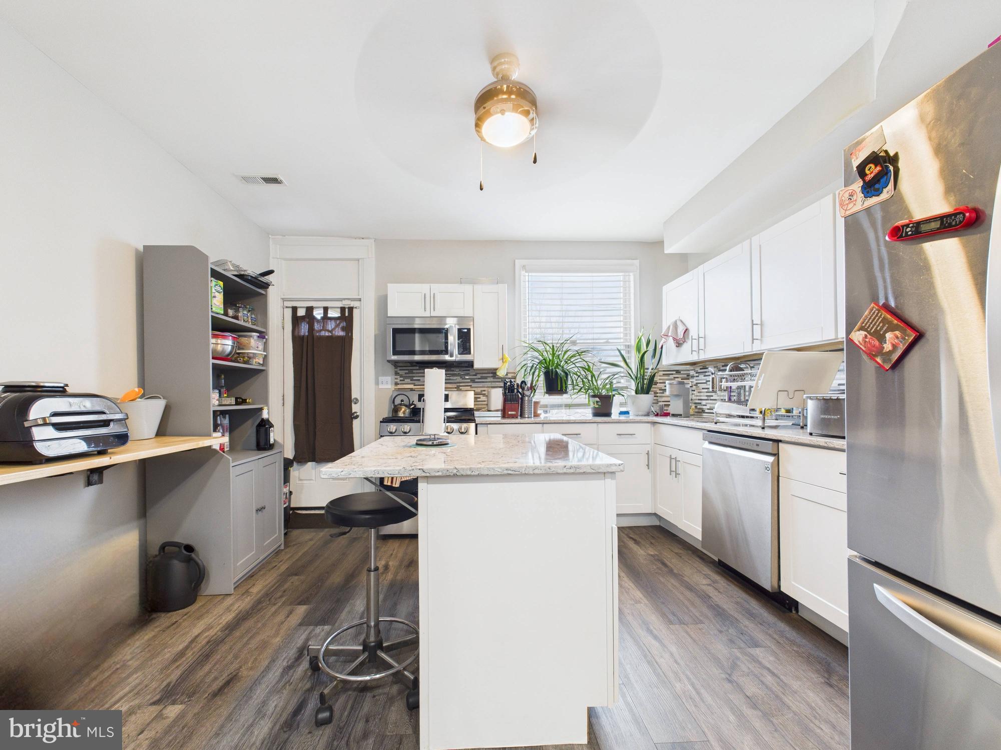 1526 North Patterson Park Avenue Baltimore, MD 21213 - Photo 27 of 31 a kitchen with refrigerator and cabinets