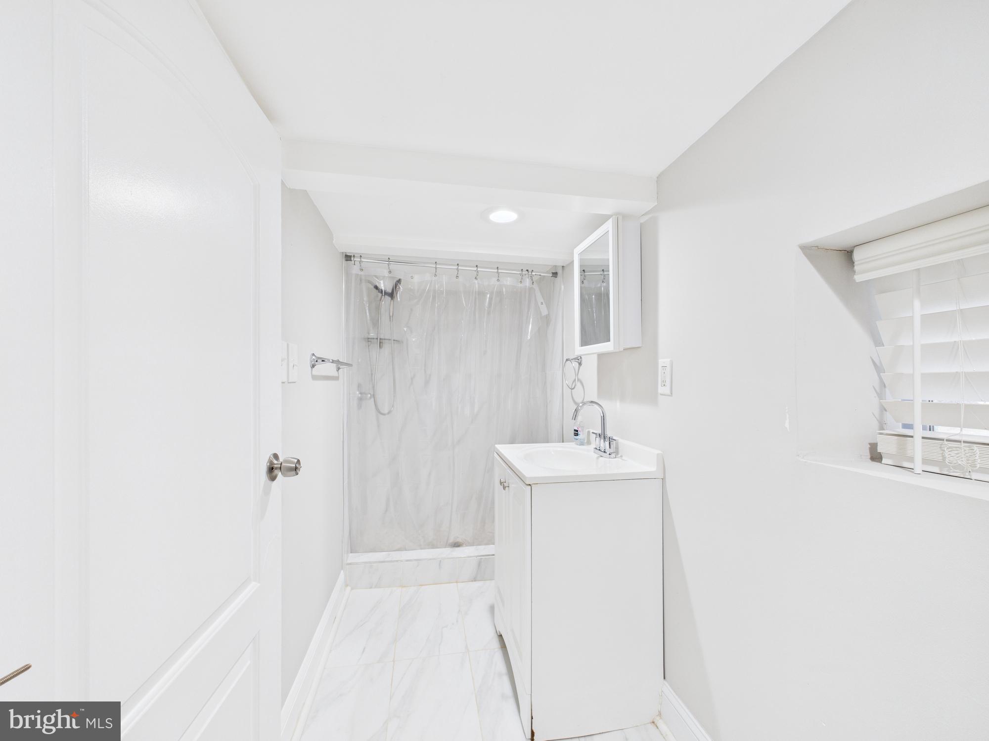 1526 North Patterson Park Avenue Baltimore, MD 21213 - Photo 28 of 31 a bathroom with a sink a toilet and mirror