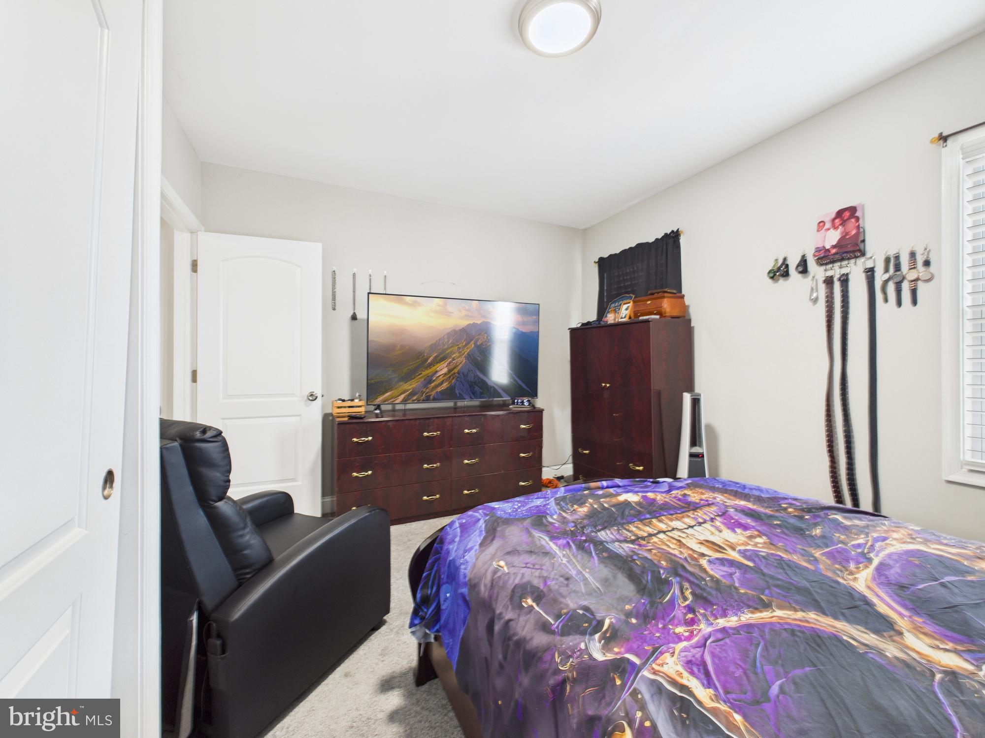 1526 North Patterson Park Avenue Baltimore, MD 21213 - Photo 7 of 31 a bedroom with a bed and dresser with mirror