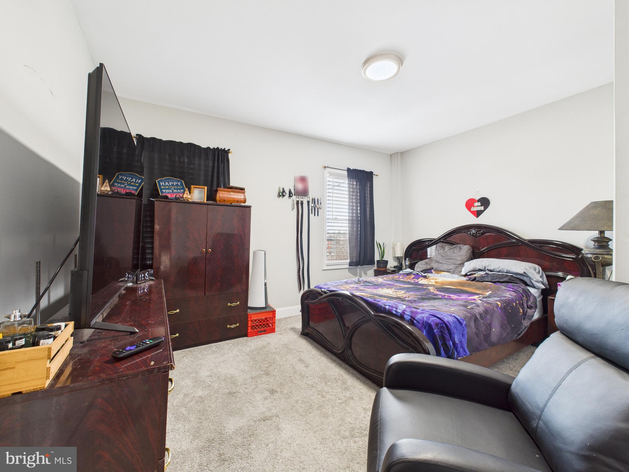 1526 North Patterson Park Avenue Baltimore, MD 21213 - Photo 10 of 31 a bed room with a bed and a television