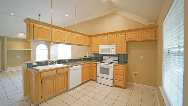 a kitchen with stainless steel appliances granite countertop a sink and cabinets
