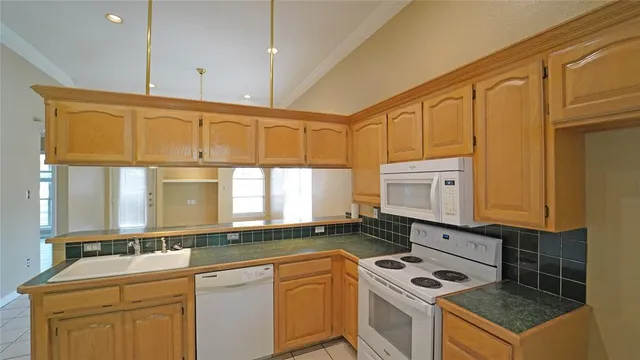 a kitchen that has a sink and a stove