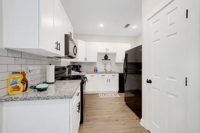 a kitchen with granite countertop lots of counter top space and appliances