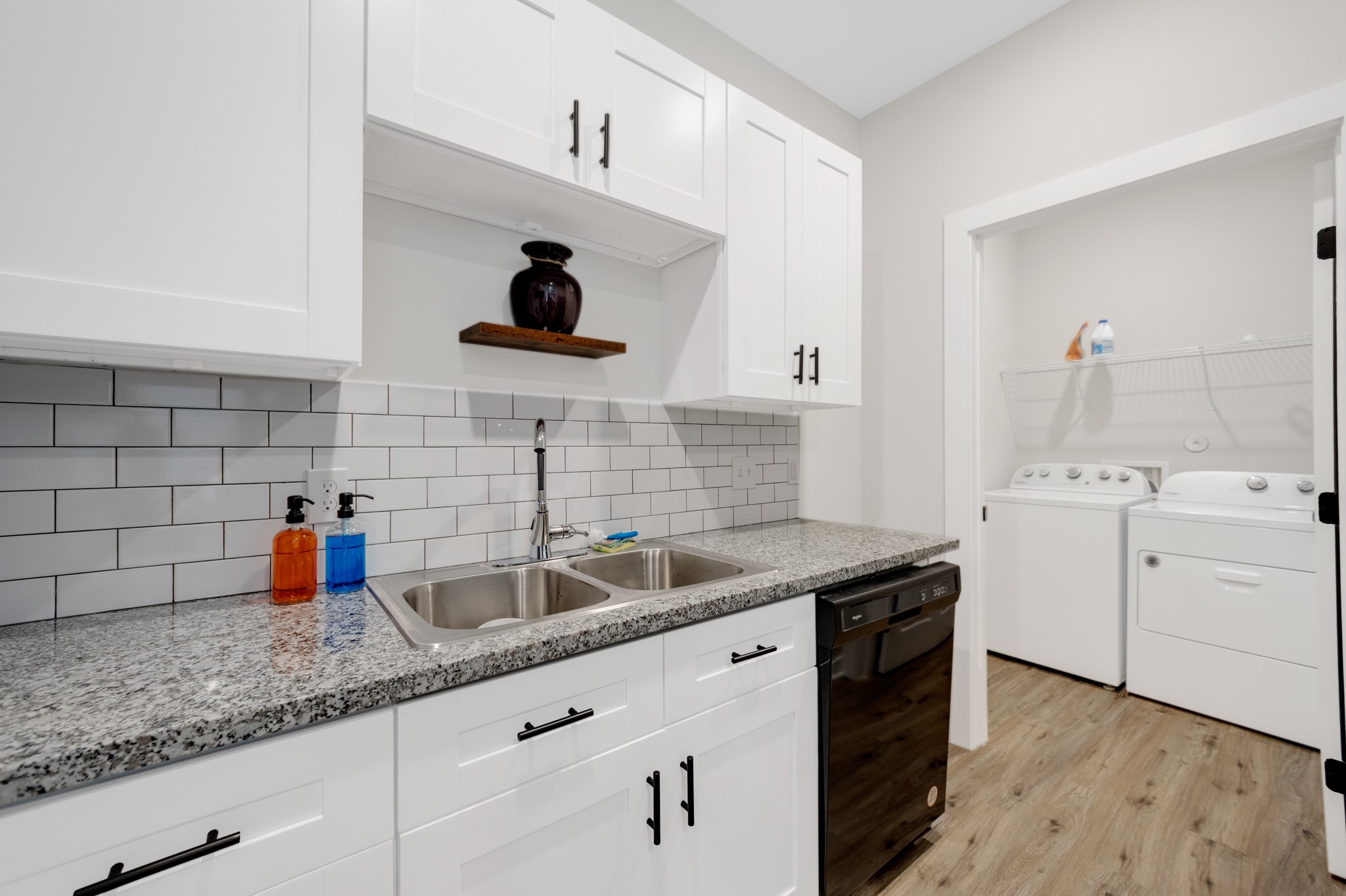 10317 Lake Road, Unit 9D Houston, TX 77070 - Photo 15 of 20 a kitchen with white cabinets and sink