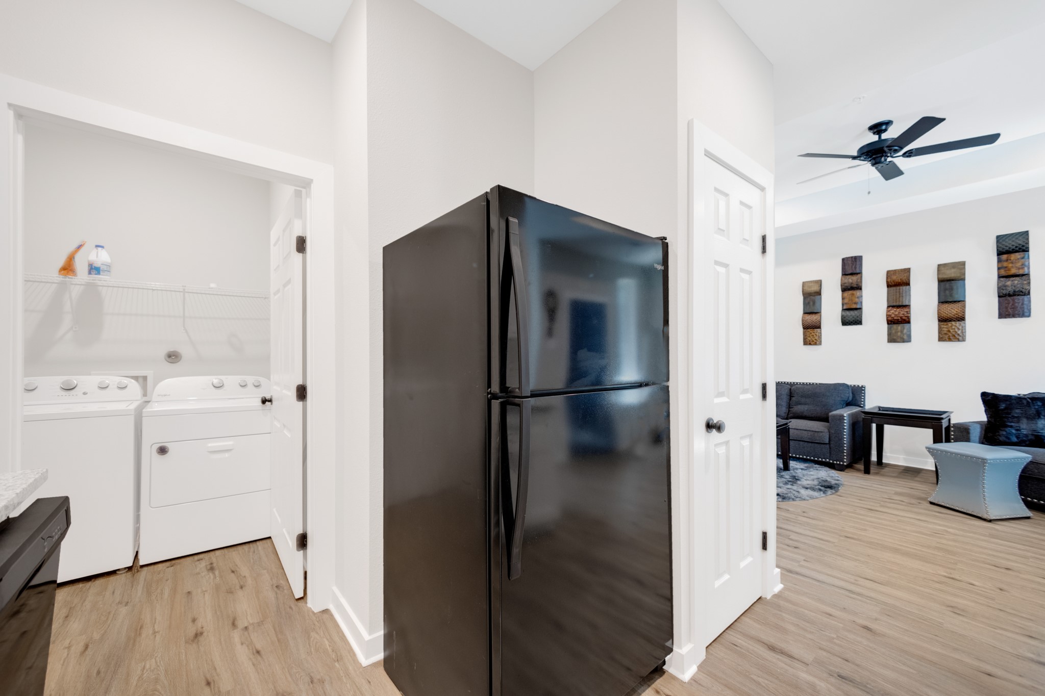 10317 Lake Road, Unit 9D Houston, TX 77070 - Photo 16 of 20 a kitchen with stainless steel appliances a refrigerator and wooden floor