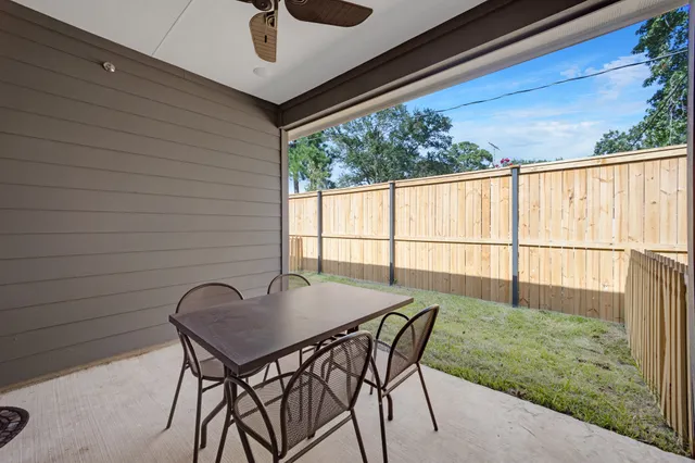 a view of a patio with a table and chairs