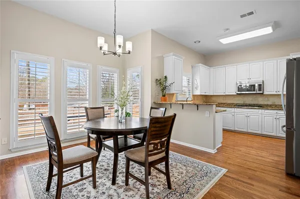 a view of a dining room with furniture window and wooden floor