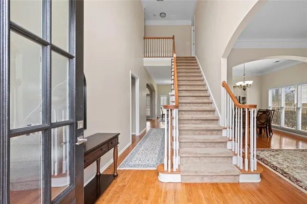 a view of entryway and hall with wooden floor