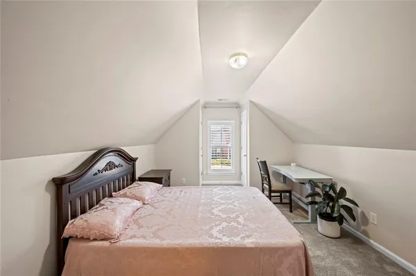 a bedroom with a bed next to a window