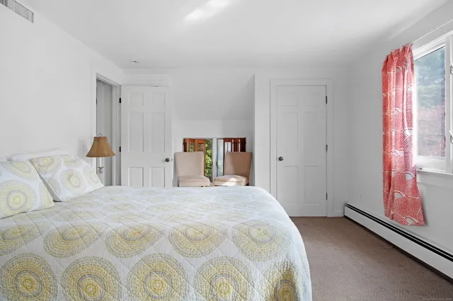 a spacious bedroom with a bed and a window