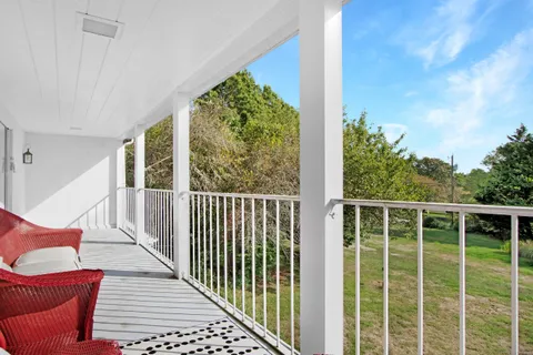 a view of a balcony with wooden floor