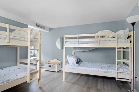 a bedroom with a bunk bed and a window