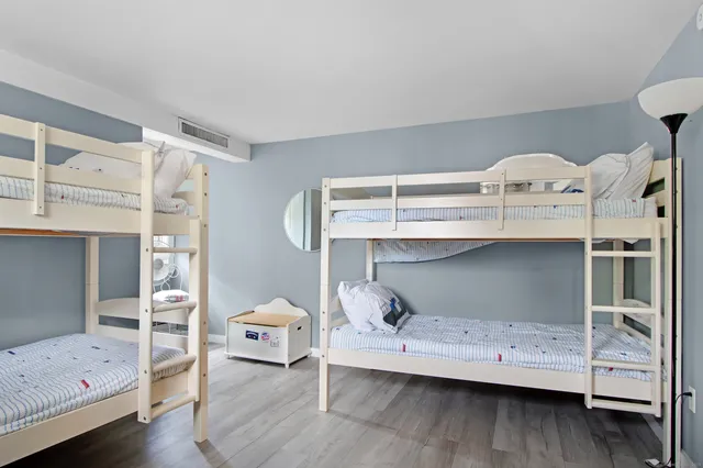a bedroom with a bunk bed and a window