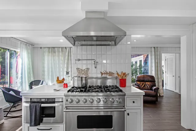 a kitchen with a stove and a chandelier