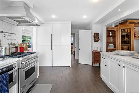 a kitchen with stainless steel appliances granite countertop a stove and a refrigerator