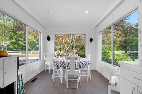 a view of a dining room with furniture window and wooden floor