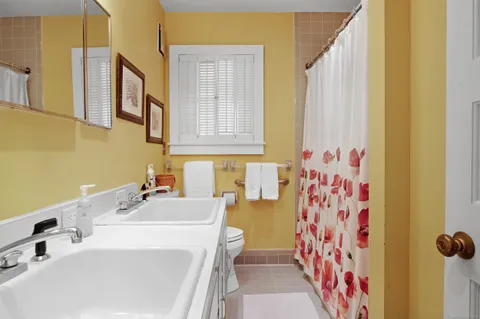 a bathroom with a sink and a curtain