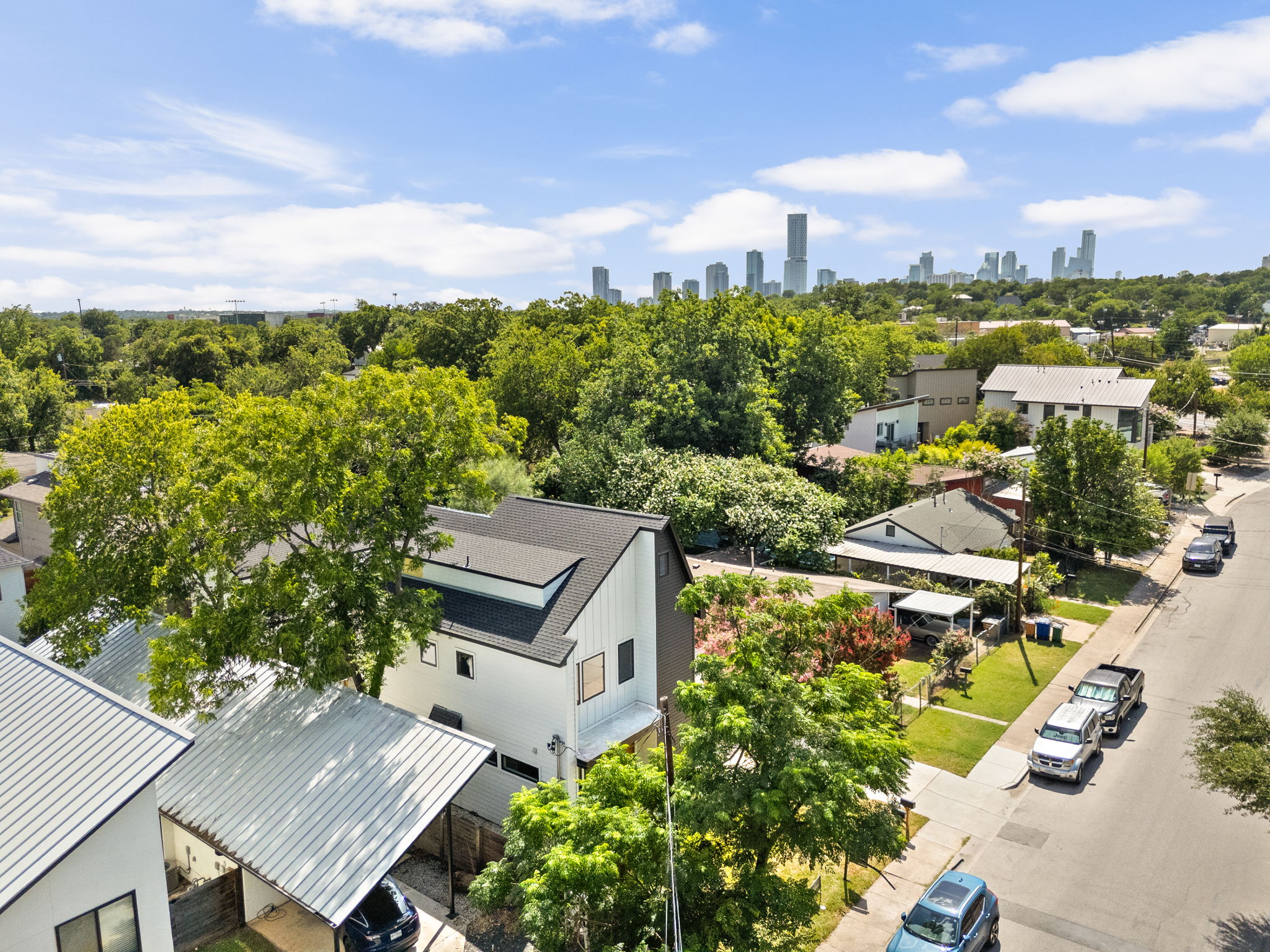 2717 Lyons Road, Unit 1 Austin, TX 78702 - Photo 36 of 40 An aerial perspective reveals a vibrant neighborhood with a city skyline backdrop.