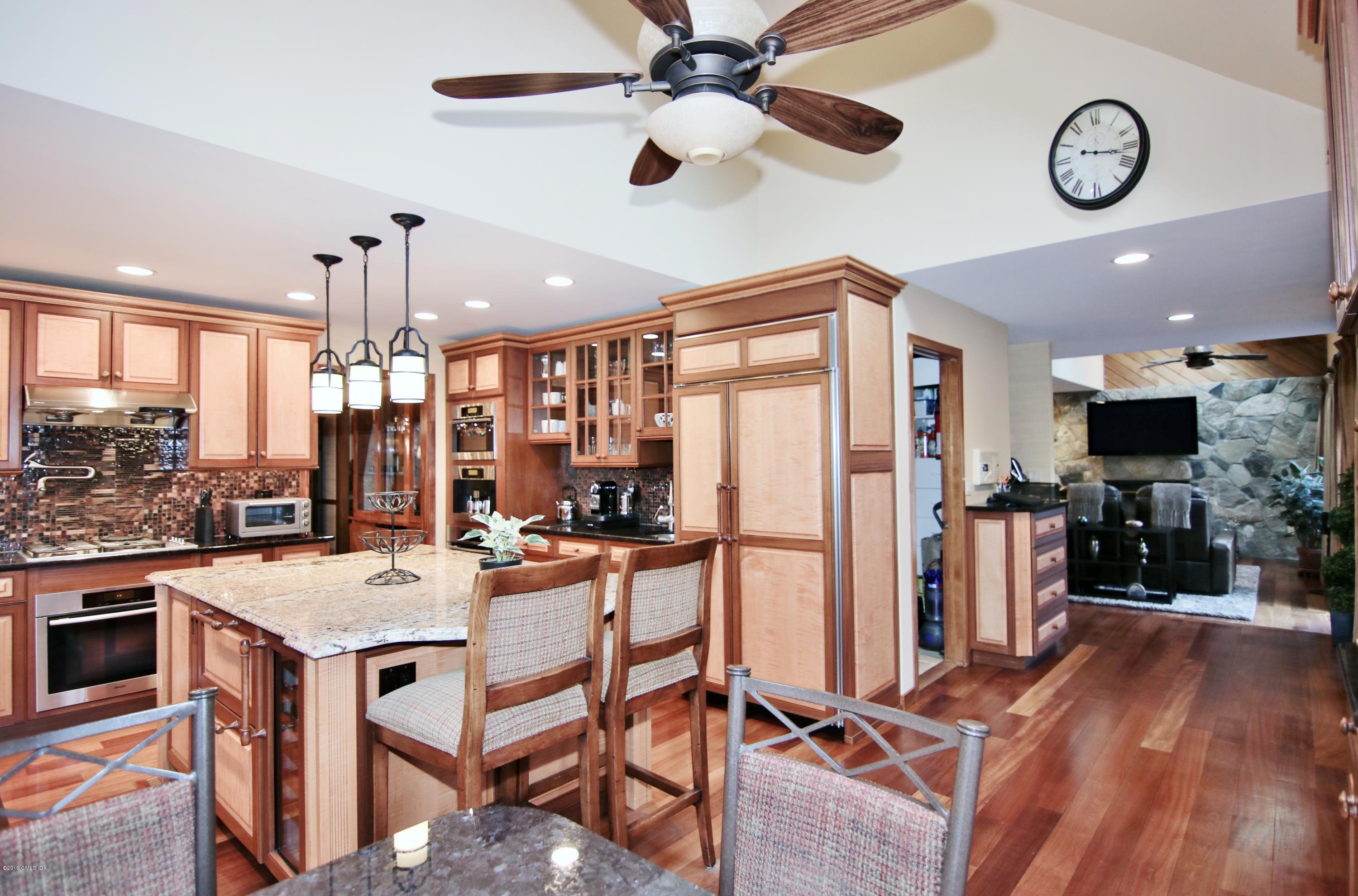 737 Rock Rimmon Road Stamford, CT 06903 - Photo 13 of 38 a kitchen with stainless steel appliances a stove a refrigerator a oven a sink with a dining table and chairs