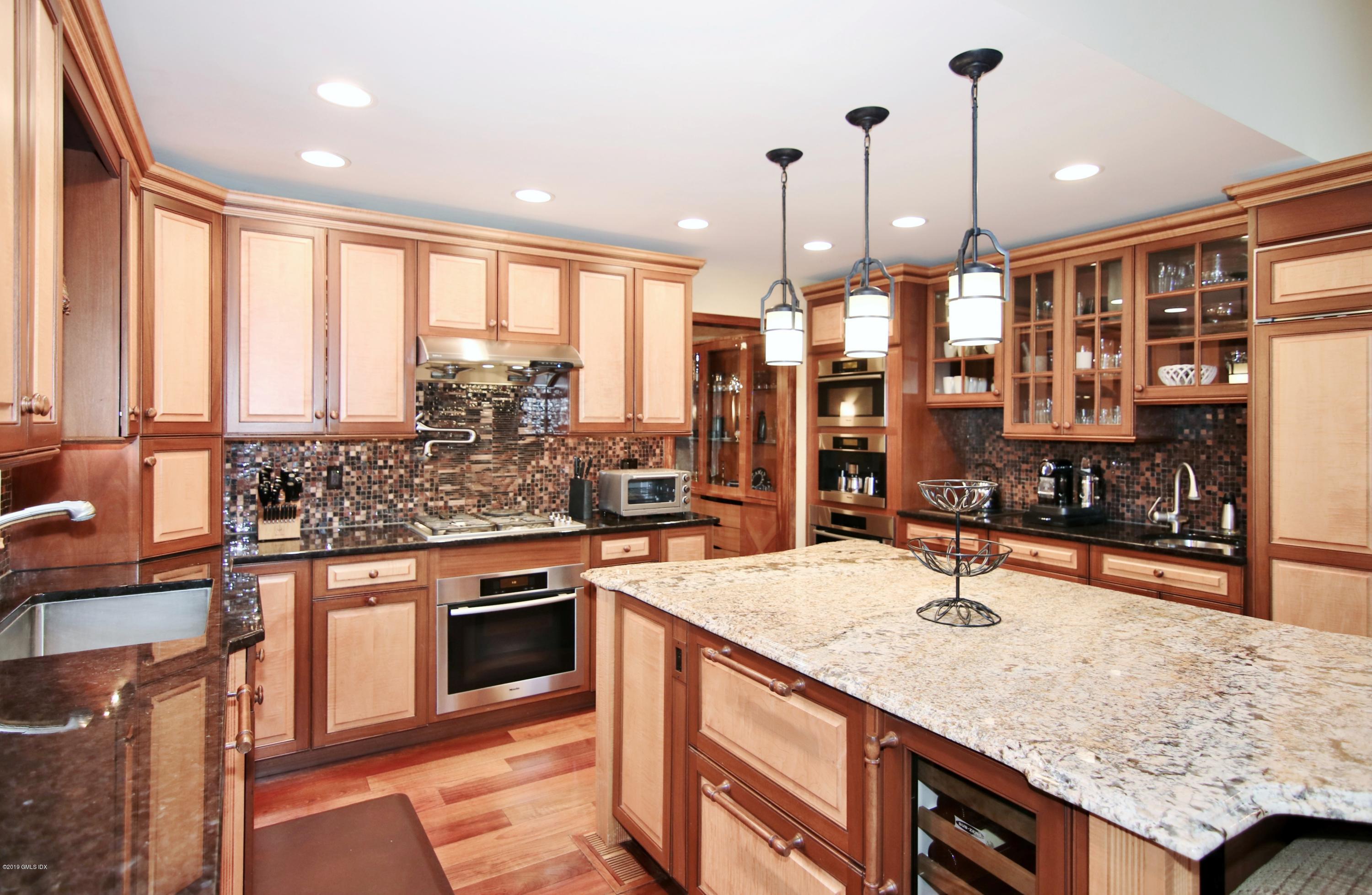 737 Rock Rimmon Road Stamford, CT 06903 - Photo 16 of 38 a kitchen with stainless steel appliances granite countertop a sink stove and refrigerator