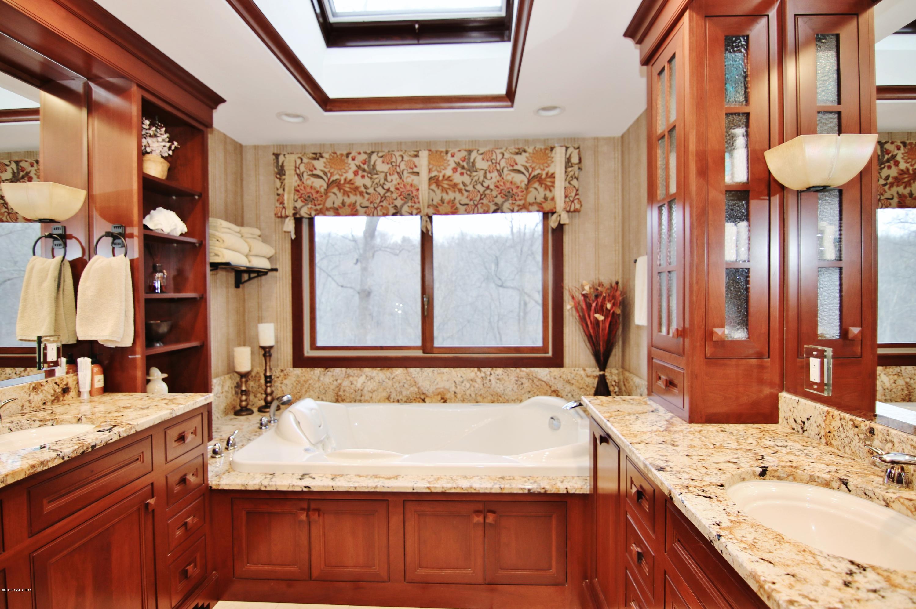 737 Rock Rimmon Road Stamford, CT 06903 - Photo 23 of 38 a bathroom with a granite countertop sink and a mirror