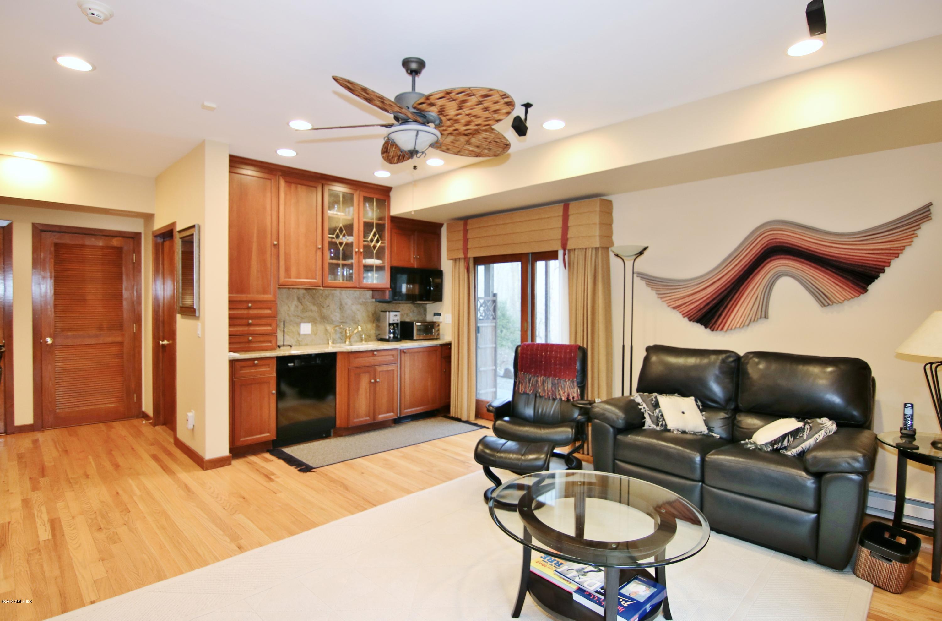 737 Rock Rimmon Road Stamford, CT 06903 - Photo 28 of 38 a living room with stainless steel appliances kitchen island granite countertop furniture and a kitchen view