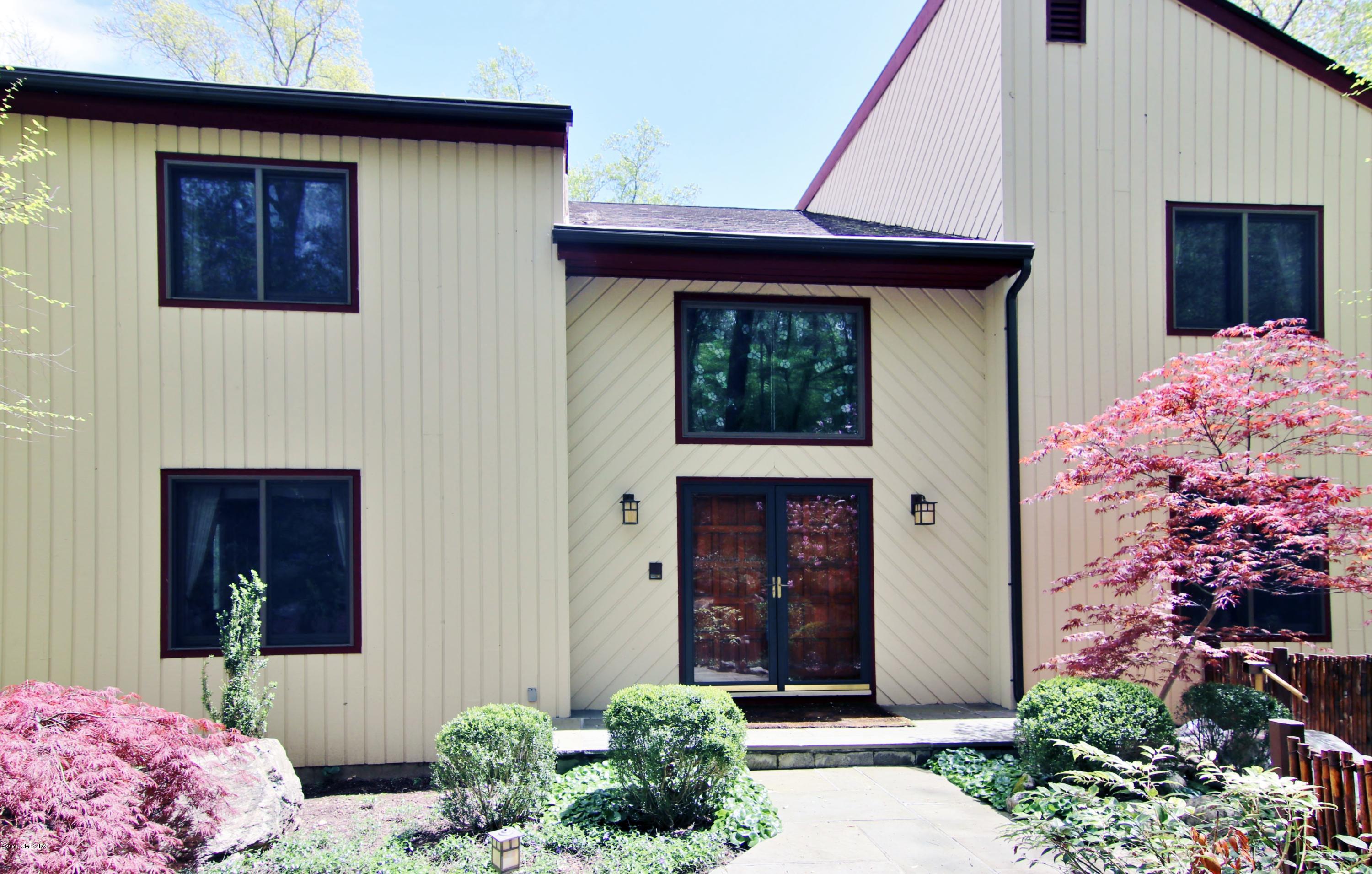 737 Rock Rimmon Road Stamford, CT 06903 - Photo 3 of 38 a front view of a house with potted plants