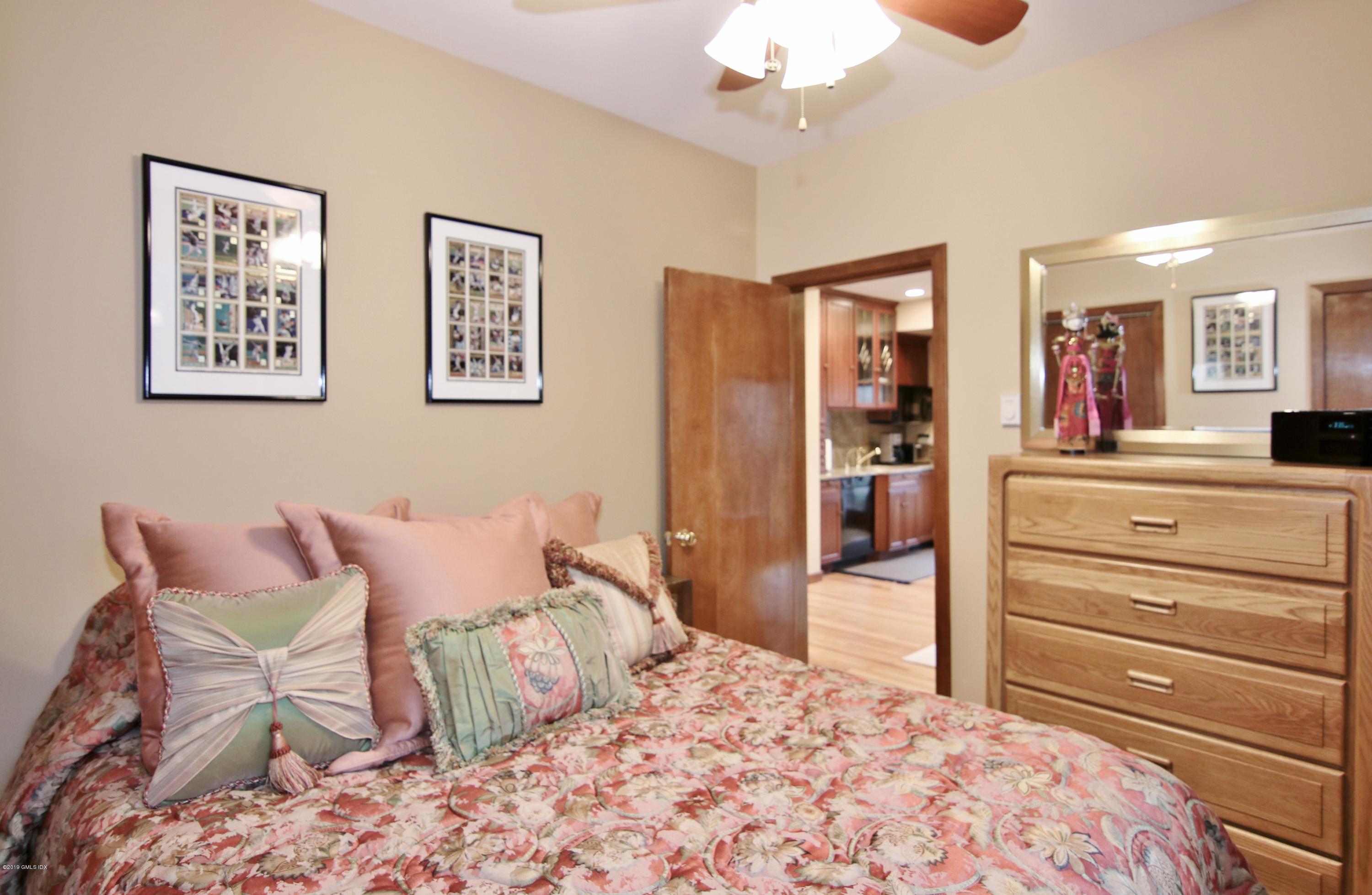 737 Rock Rimmon Road Stamford, CT 06903 - Photo 31 of 38 a bedroom with a bed and wooden floor