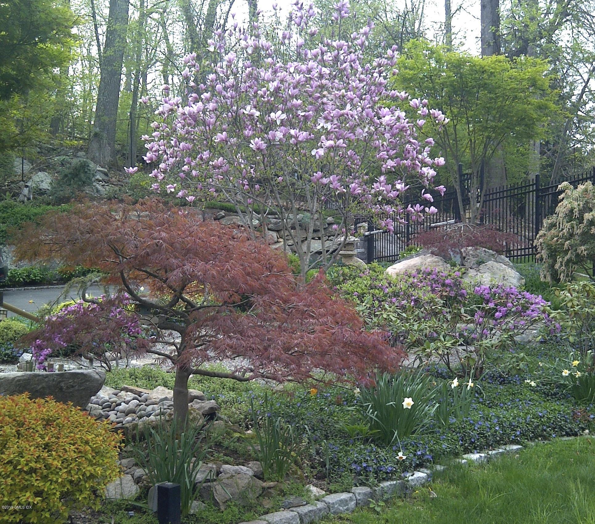 737 Rock Rimmon Road Stamford, CT 06903 - Photo 4 of 38 a backyard of a house with lots of green space and lake view