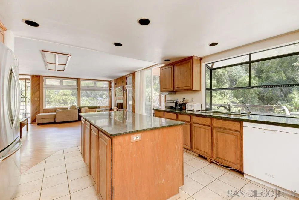 4954 Sun Valley Road Del Mar, CA 92014 - Photo 12 of 32 a kitchen with granite countertop a stove a sink and a refrigerator