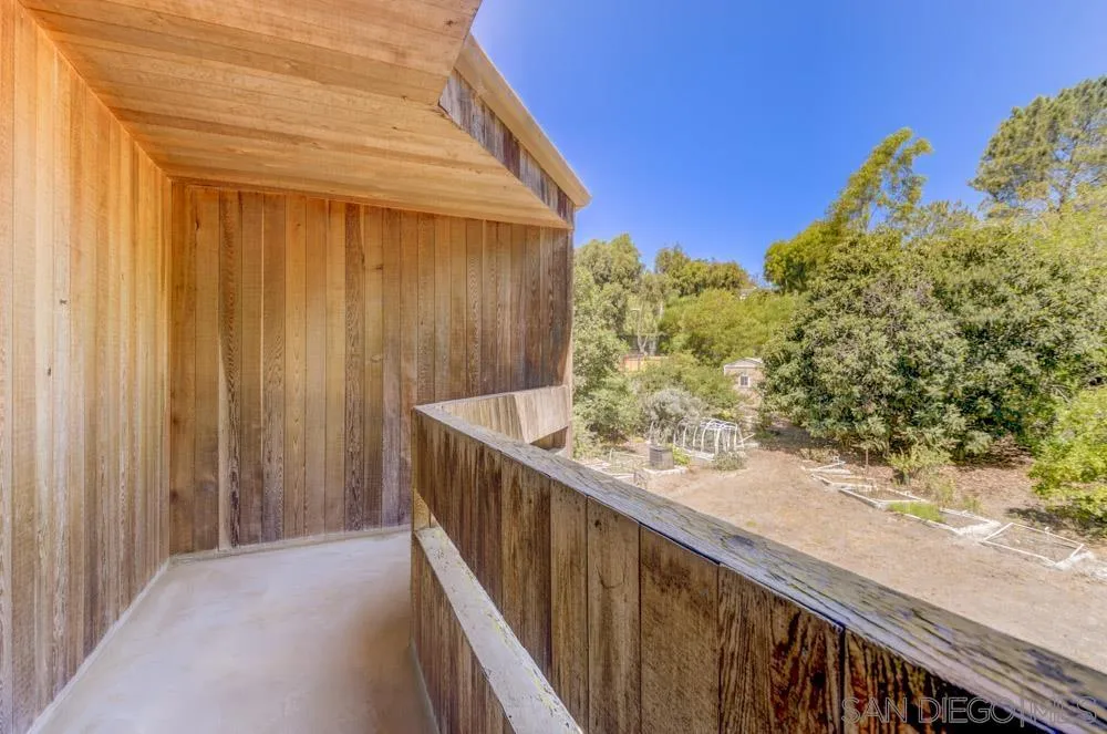 4954 Sun Valley Road Del Mar, CA 92014 - Photo 21 of 32 a view of a balcony with chair and wooden fence