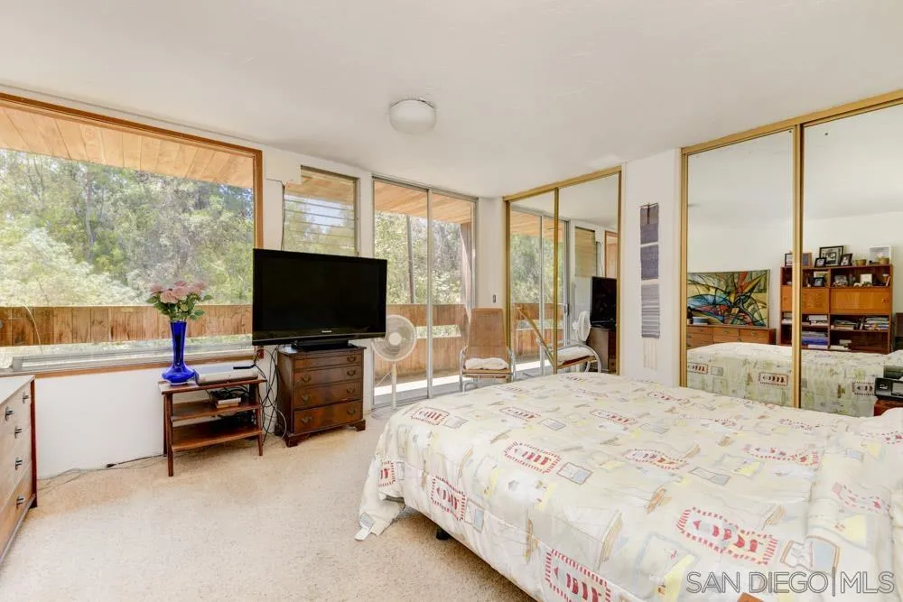 4954 Sun Valley Road Del Mar, CA 92014 - Photo 22 of 32 a bedroom with a bed and large window