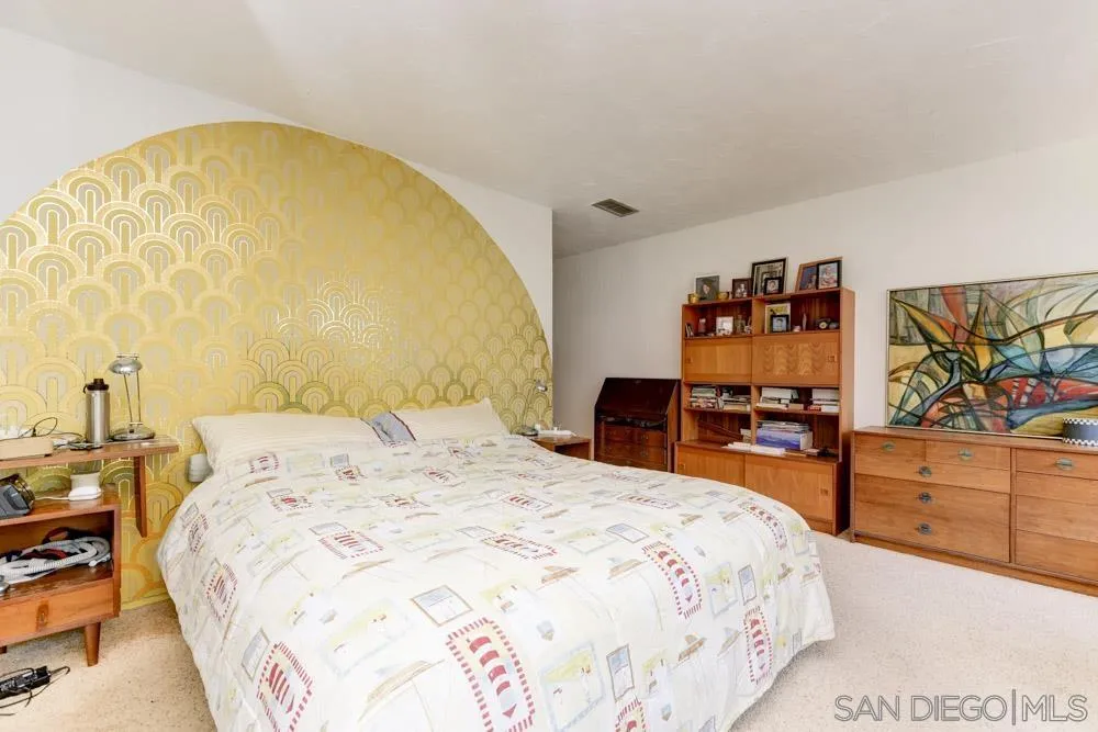 4954 Sun Valley Road Del Mar, CA 92014 - Photo 23 of 32 a spacious bedroom with a bed and a flat screen tv