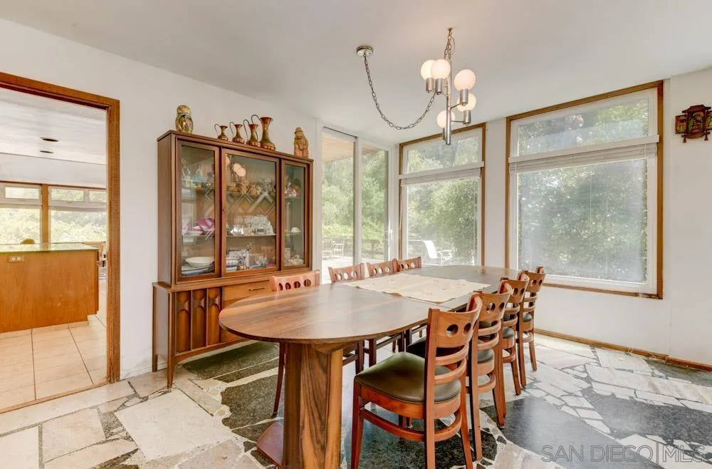 4954 Sun Valley Road Del Mar, CA 92014 - Photo 6 of 32 a dining room with furniture a chandelier and wooden floor
