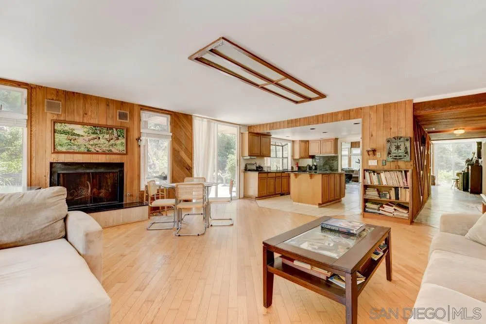 4954 Sun Valley Road Del Mar, CA 92014 - Photo 7 of 32 a living room with furniture and a floor to ceiling window