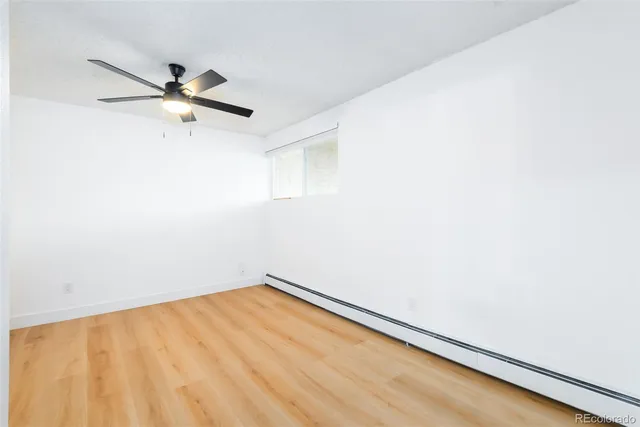a view of a room with a ceiling fan